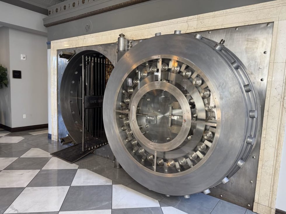 The original 16-ton bank vault door now serves as the entrance to The Treasury Bar inside the...