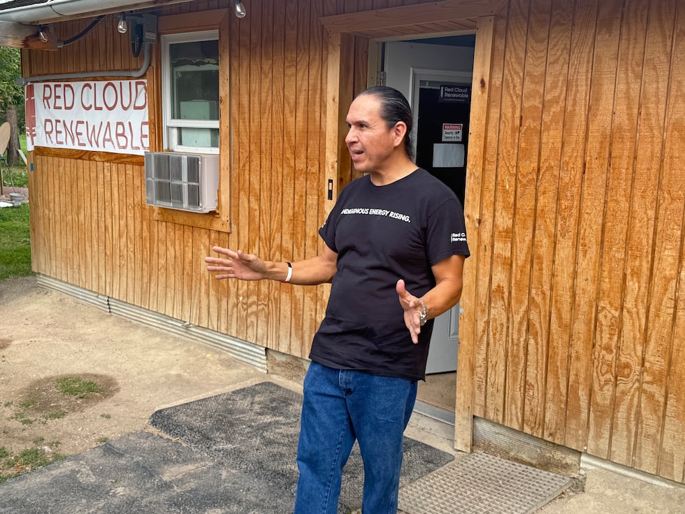 John Red Cloud, vice president of Red Cloud Renewable in Pine Ridge, S.D., welcomes visitors...