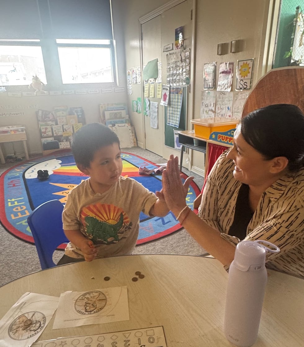 Education programming leader Nicole Pourier with a student in the FACE program at Little Wound...