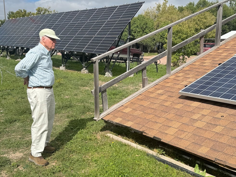 Potential donor Mid Tilghman, on Sept. 18, 2026, examines a model of a roof-mounted solar...